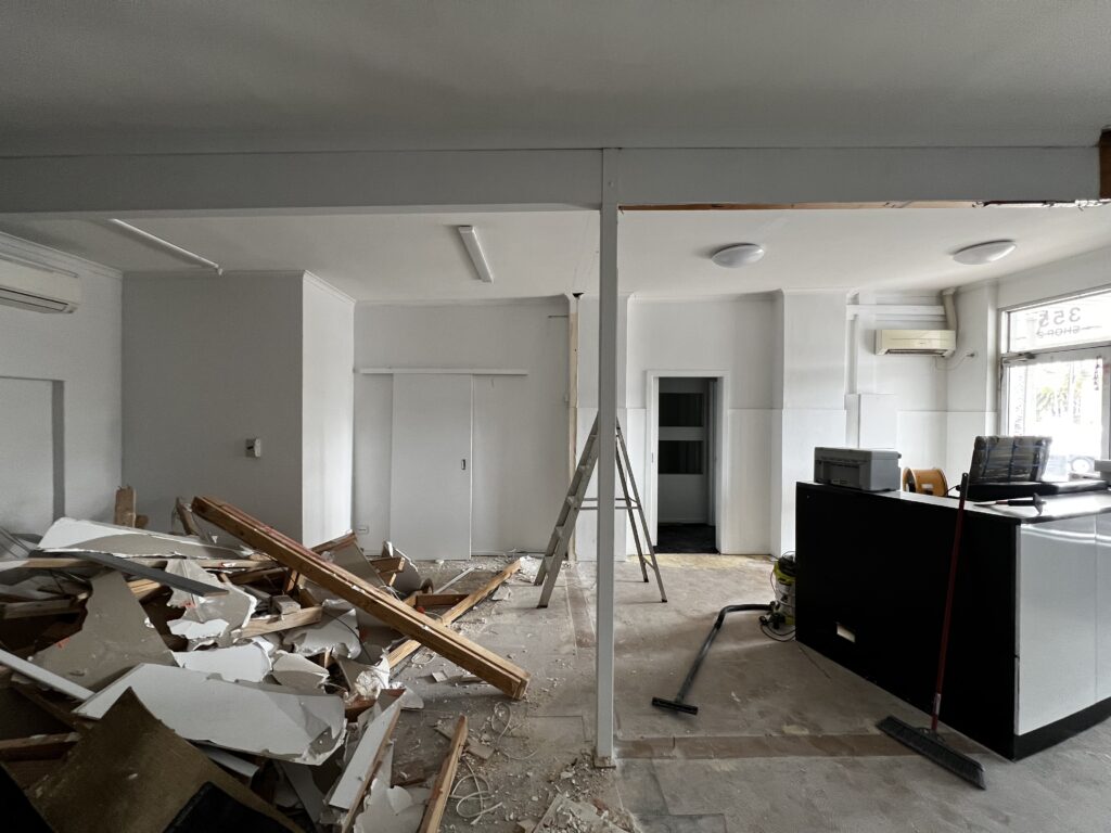 Walls knocked down inside the new KOM Coffee Roasters shop, a team effort with the owners