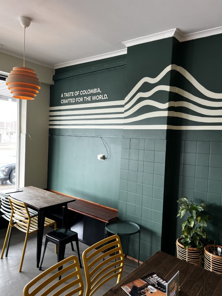 Mountain line mural and A taste of Colombia lettering at KOM Coffee Roasters