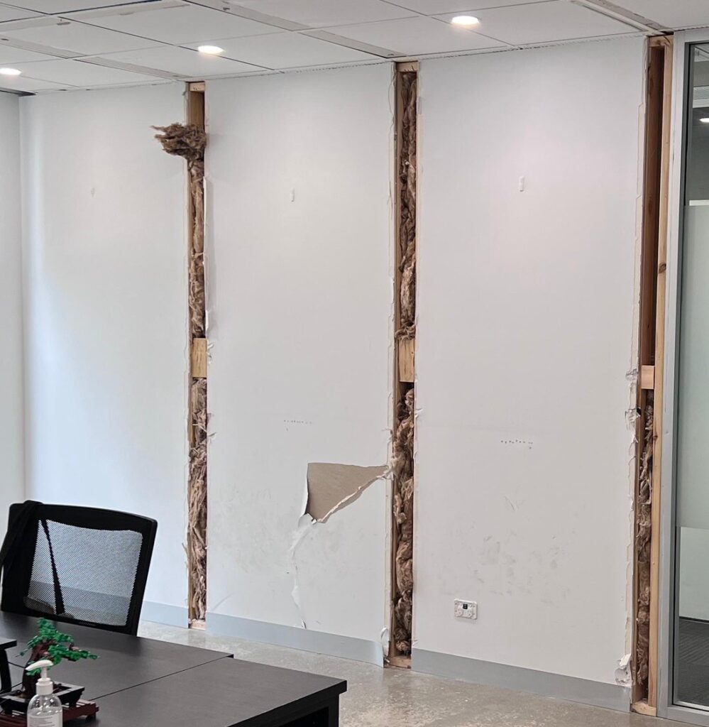 Damaged office wall at All In Advisory in Kent Town before the pop art mural