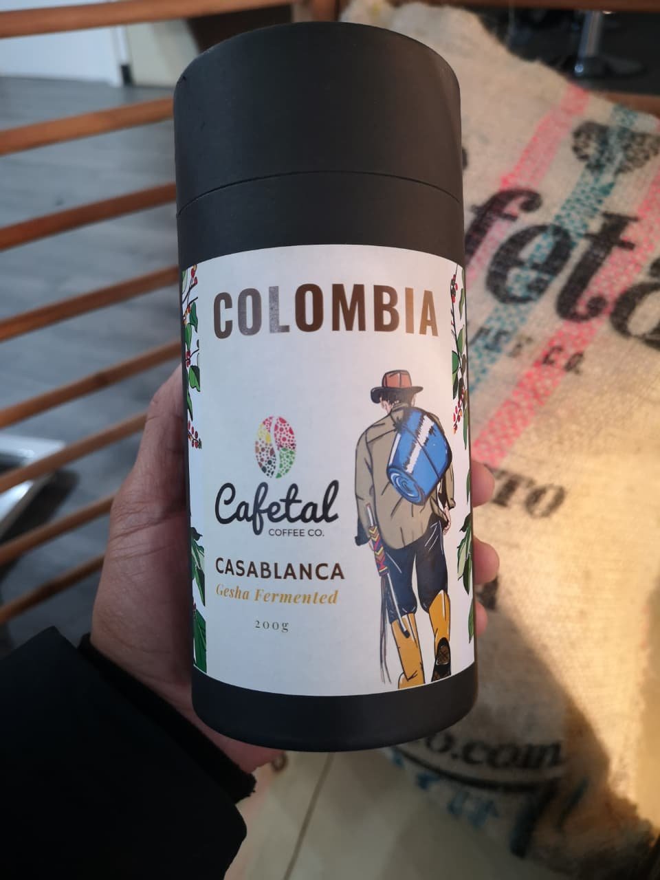 Cafetal Coffeeco Colombian coffee packaging featuring the coffee farmer illustration from the mural