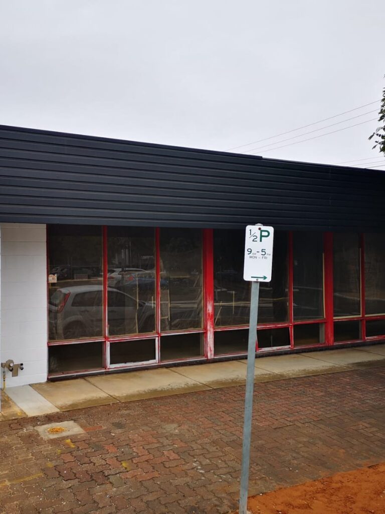 Cafetal Coffeeco exterior with the upper facade repainted black