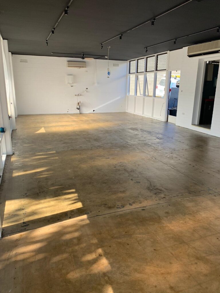 Cafetal Coffeeco interior with the ceiling painted black and fresh white walls, ready for fit-out