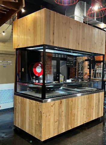Cumbia Bar Kitchen stall sanded back to bare timber during preparation