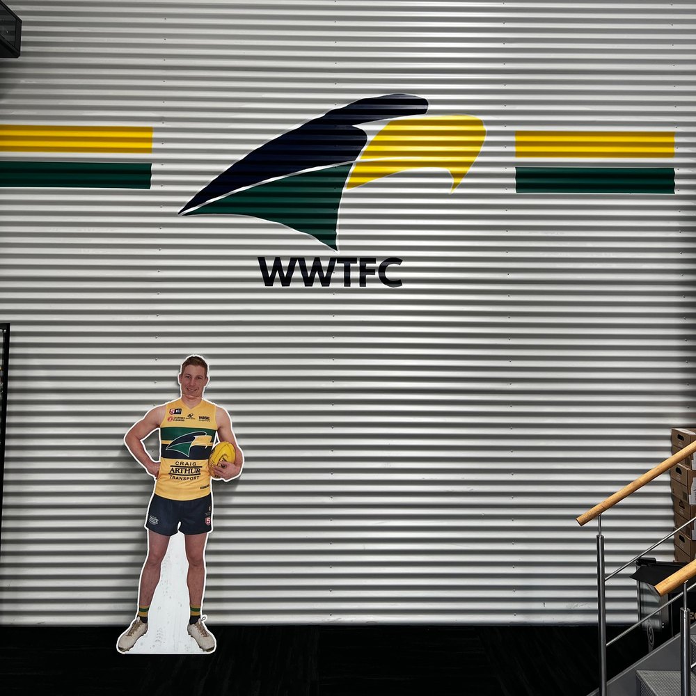 Finished hand-painted WWTFC Eagles logo on corrugated metal at Craig Arthur Transport