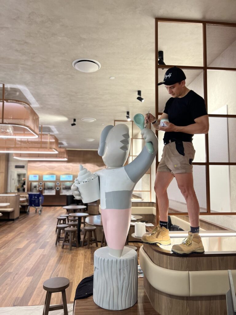 Diegodalo painting the base colours on the Yo-Chi Bear sculpture at Tri Plaza